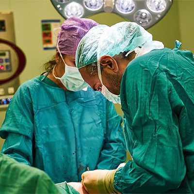a group of doctors in scrubs in an operating room