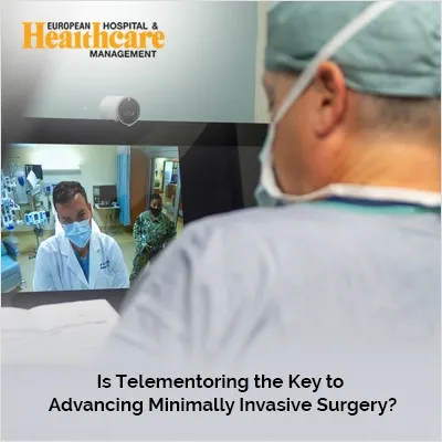 a man wearing surgical mask and looking at a monitor