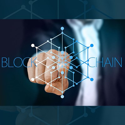 a man in a suit touching a blockchain logo