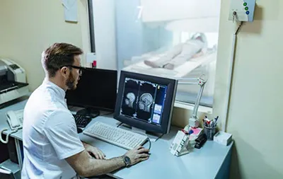 Radiologist analyzing MRI with artificial intelligence-assisted imaging overlay