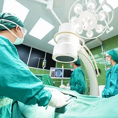 a group of doctors performing surgery in an operating room