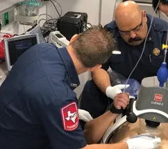 a group of men in a room with medical equipment